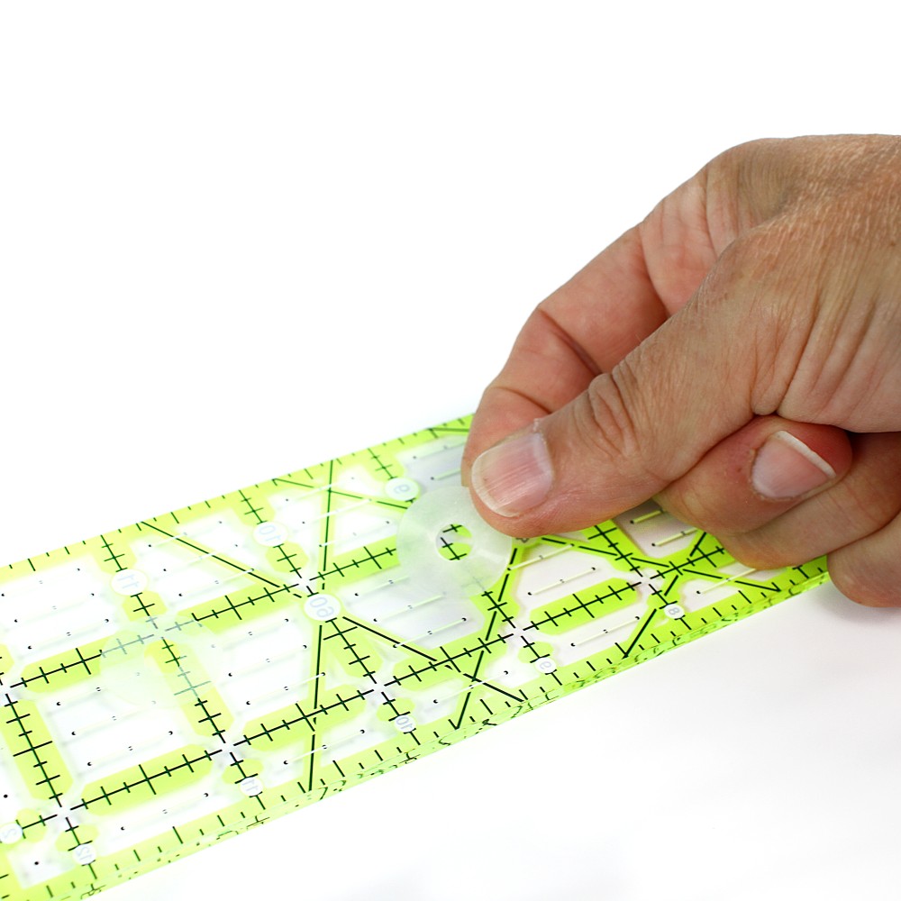 Applying a clear Gypsy Quilter No-Slip Grip Dot to an acrylic quilting ruler
