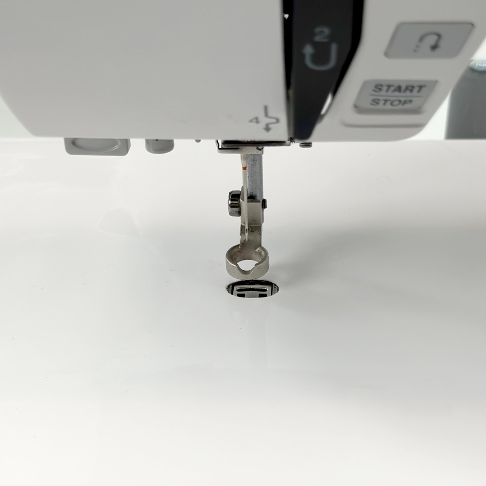 Queen Size Supreme Slider needle opening aligned with a sewing machine throat plate