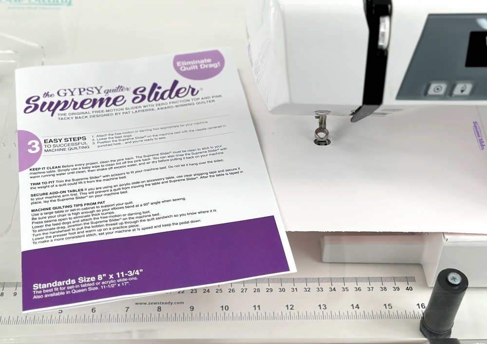 The Gypsy Quilter Queen Size Supreme Slider installed around the needle of a sewing machine TGQ144